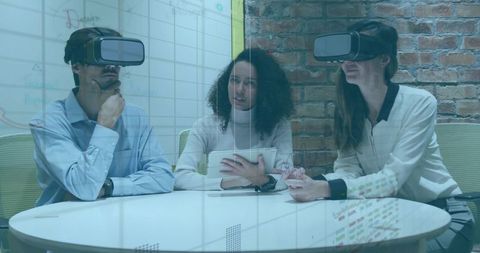 Collaborative team testing virtual reality prototype during design session with tablet