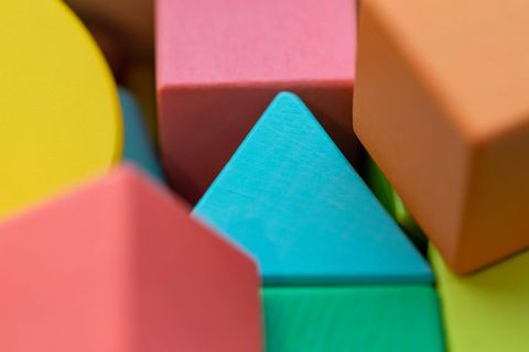 Colorful wooden toy blocks close-up with various shapes and bright hues