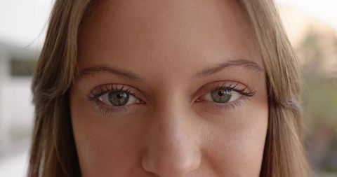 Close-up Portrait of Woman with Hazel Green Eyes in Sunlight