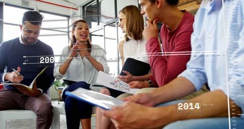 Team Collaborating During Data Analysis Meeting in Modern Office