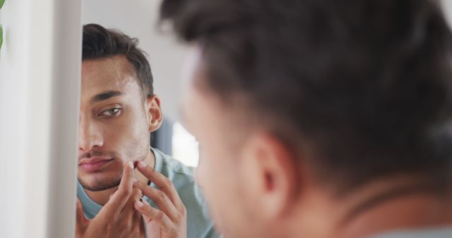 Young Man Checking Skin Blemish in Mirror - Download Free Stock Images Pikwizard.com