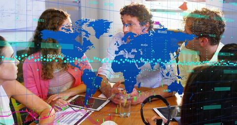 Multinational Team Analyzing Global Data Dashboard Over Meeting Table With Tablets and Charts
