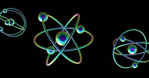Colorful atomic models on black background illustrating quantum concepts
