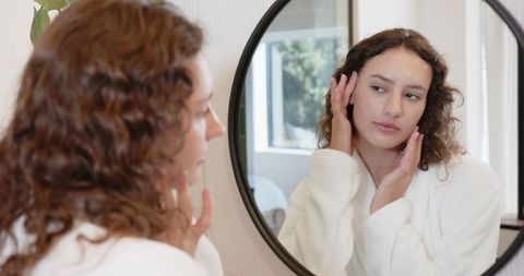 Woman Practicing Skincare Routine with Confidence in Home Setting