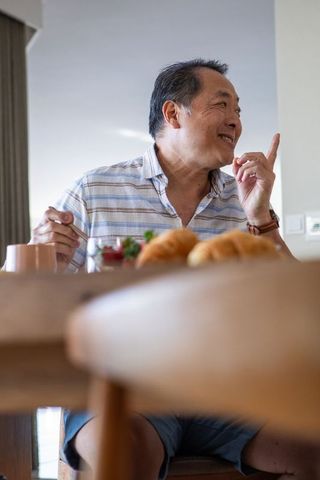 Senior Man Enjoying Breakfast Gesture Casual Home Scene
