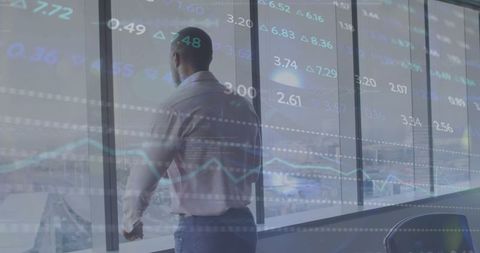 Businessman Overlooking City With Financial Data Overlay