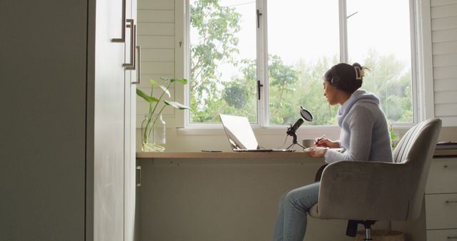 Image of biracial woman taking part in online interview on laptop at home - Download Free Stock Photos Pikwizard.com