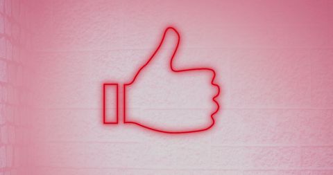 Glowing thumbs up icon on pink brick background