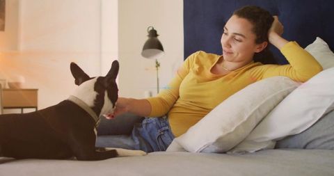 Woman Relaxing with Dog in Modern Bedroom