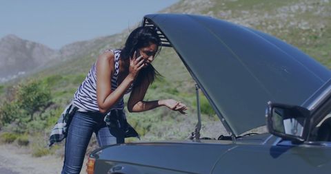 Woman Troubleshooting Car Engine Breakdown