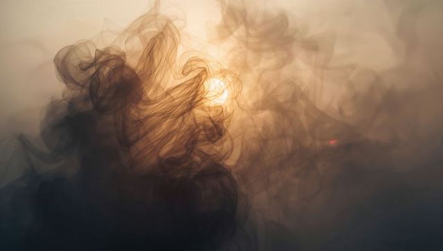 Ethereal smoke and light abstraction under hazy sky