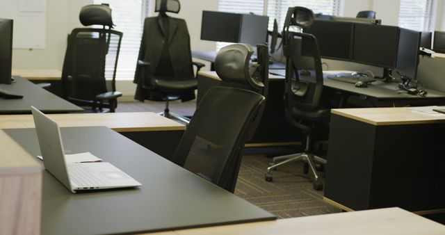 A visually appealing modern office space featuring multiple ergonomic chairs and desks. Ideal for illustrating themes like business efficiency, corporate work environment, and modern office interiors. Suitable for use in articles, websites, and promotional materials related to office furniture, workplace productivity, or corporate settings.