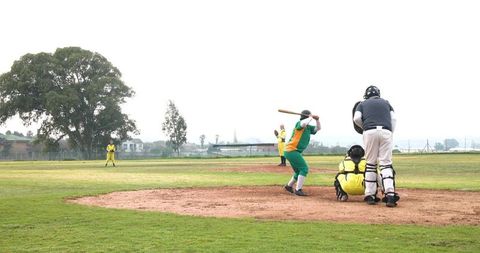 Female softball batter ready to swing at home plate