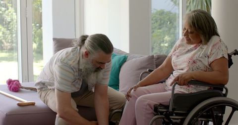 Senior couple caregiving at home with walking assistance