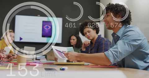 Diverse Team Analyzing Data with Digital Interfaces