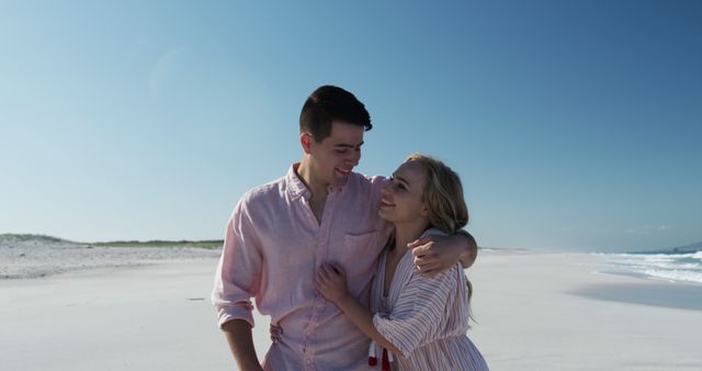 Young Couple Embracing on Sunny Beach - Download Free Stock Images Pikwizard.com