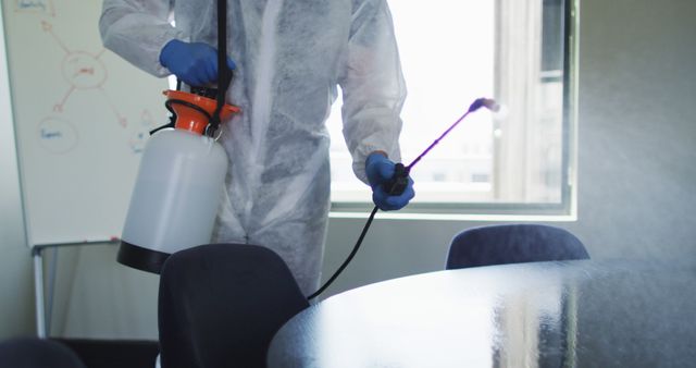 Worker Disinfecting Office Conference Room with Protective Gear - Download Free Stock Images Pikwizard.com