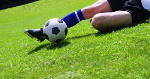 A soccer player in action on a vibrant green pitch, with copy space - Download Free Stock Photos Pikwizard.com