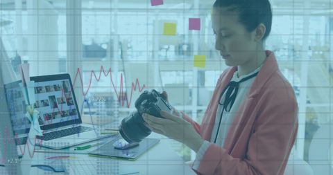 Female Creative Using Camera for Digital Project in Modern Office