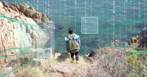 Adventurous Hiker Overlooks Ocean from Clifftop