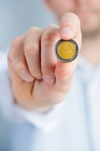 Close-up of Hand Holding Two Euro Coin