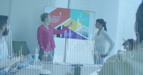 Diverse team analyzing financial data with digital overlay