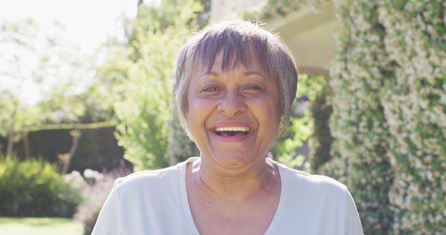 Joyful Elderly Woman Smiling Outdoors in Bright Sunlight - Download Free Stock Images Pikwizard.com