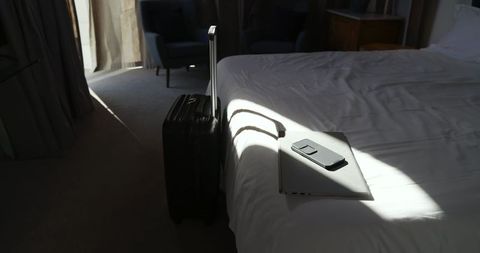 Modern Hotel Room with Suitcase and Technology
