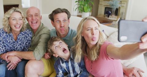 Cheerful Caucasian Family Taking Silly Selfie Together at Home