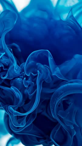 Blue pigment swirling in water, ribbon tendrils mixing vertical macro video