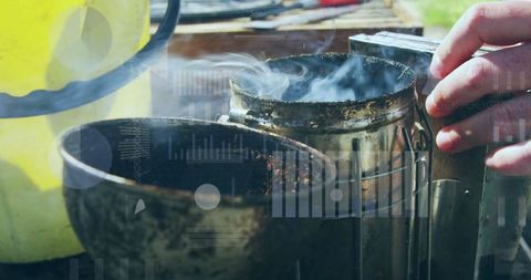 Beekeeper Handling Traditional Smoker on Sunny Day