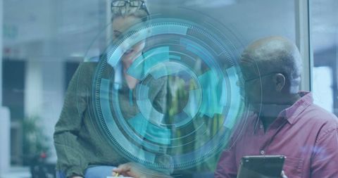 Diverse Professionals Collaborating with Digital Technology Interface in Office