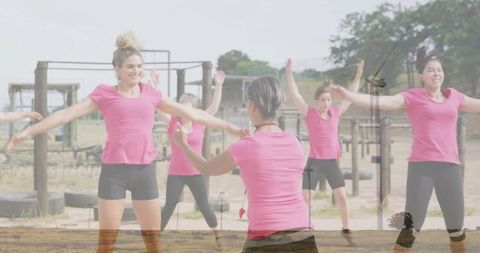 Female Fitness Class Exercising at Outdoor Gym with Instructor