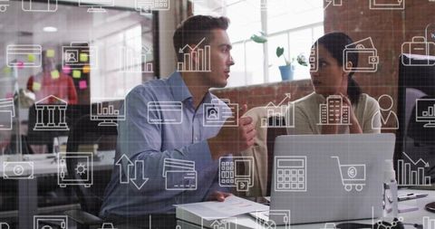 Two professionals collaborating at laptop with digital finance, analytics and ui overlays