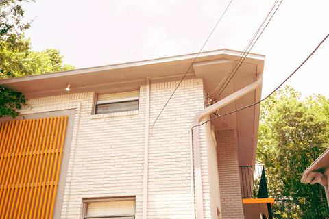 Modern Brick House with Balcony and Cable Lines