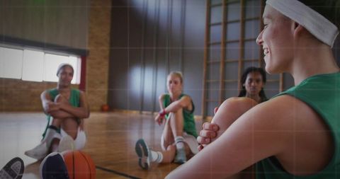 Smiling Basketball Players Enjoying Break on Indoor Court
