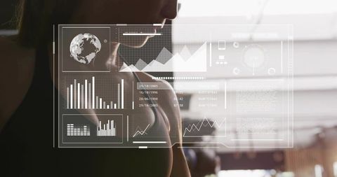 Mid-adult woman monitoring fitness performance with HUD analytics and wearable biomometrics