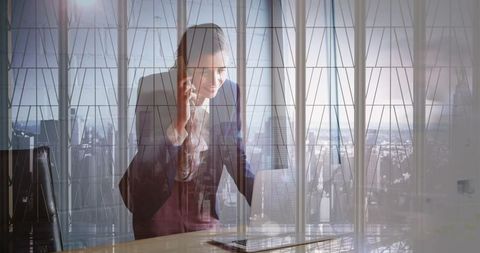 Businesswoman Communicating Through Technology Amid Cityscape