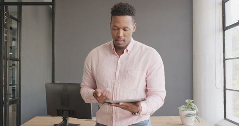 Confident Business Professional Using Tablet in Modern Office