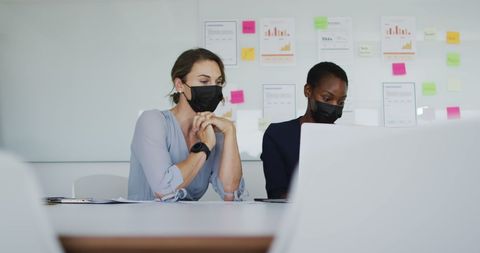 Diverse Female Colleagues Collaborating in Modern Office with Masks - Download Free Stock Images Pikwizard.com