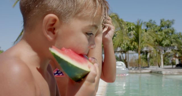 Happy caucasian siblings eating watermelon at swimming pool at beach house. Vacation, free time, summer and childhood.