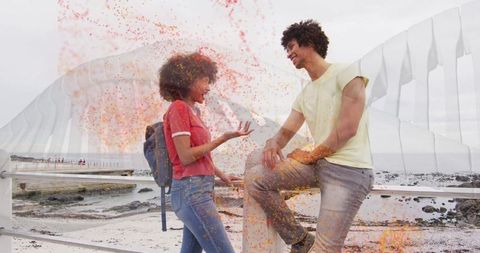 Friends having casual conversation at coastal lookout with railing