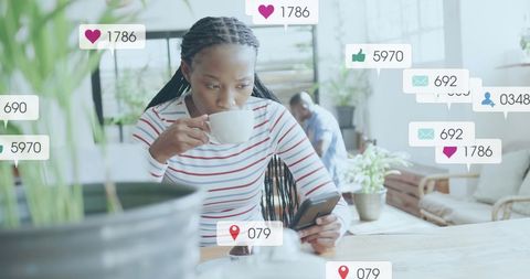 Woman Engaging with Social Media Alerts in Coffee Shop