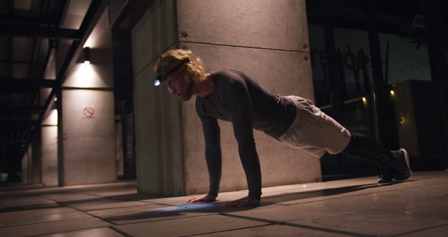 Determined Man Doing Push-ups at Night Wearing Headlamp - Download Free Stock Images Pikwizard.com