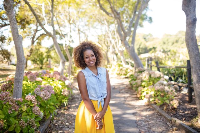 Portrait of smiling woman standing in park