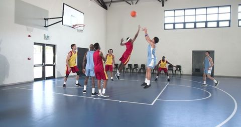 Youth Basketball Players Competing on Indoor Court