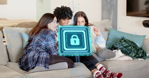 Friends sharing tablet with holographic padlock graphic representing home cybersecurity