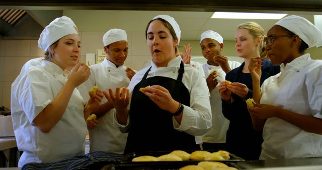 Diverse culinary students tasting freshly baked pastries in professional kitchen - Download Free Stock Images Pikwizard.com