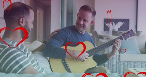 Happy Gay Couple Relaxing Together with Guitar