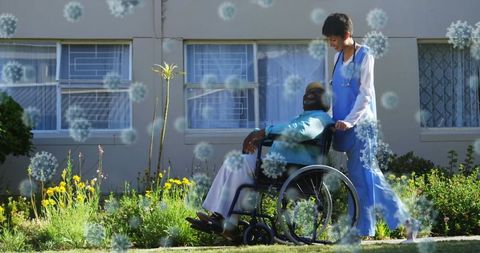 Healthcare Worker Assisting Man in Wheelchair with Virus Concept Overlay